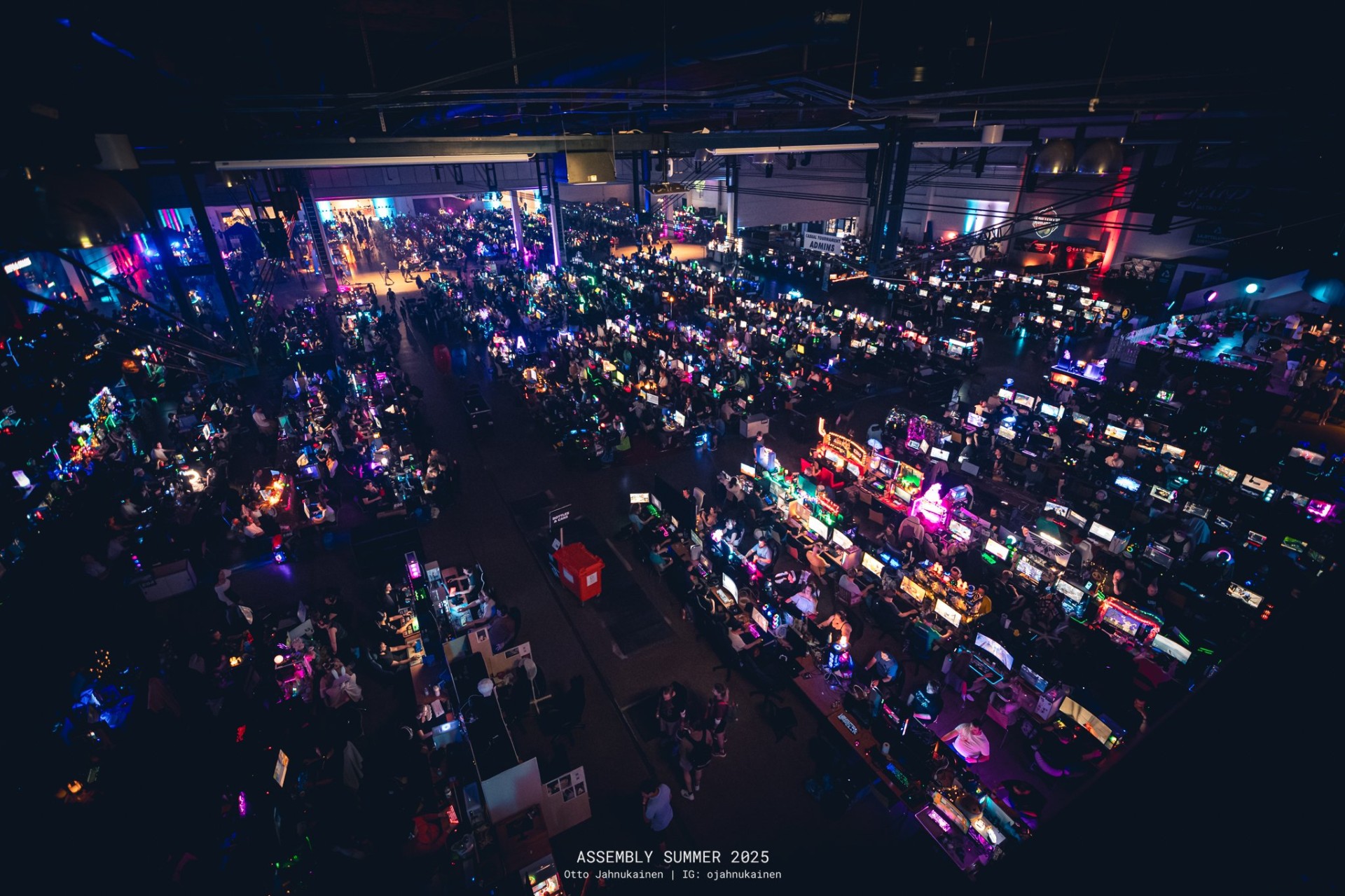 Aerial view of the Assembly LAN floor at night, hundreds of glowing monitors